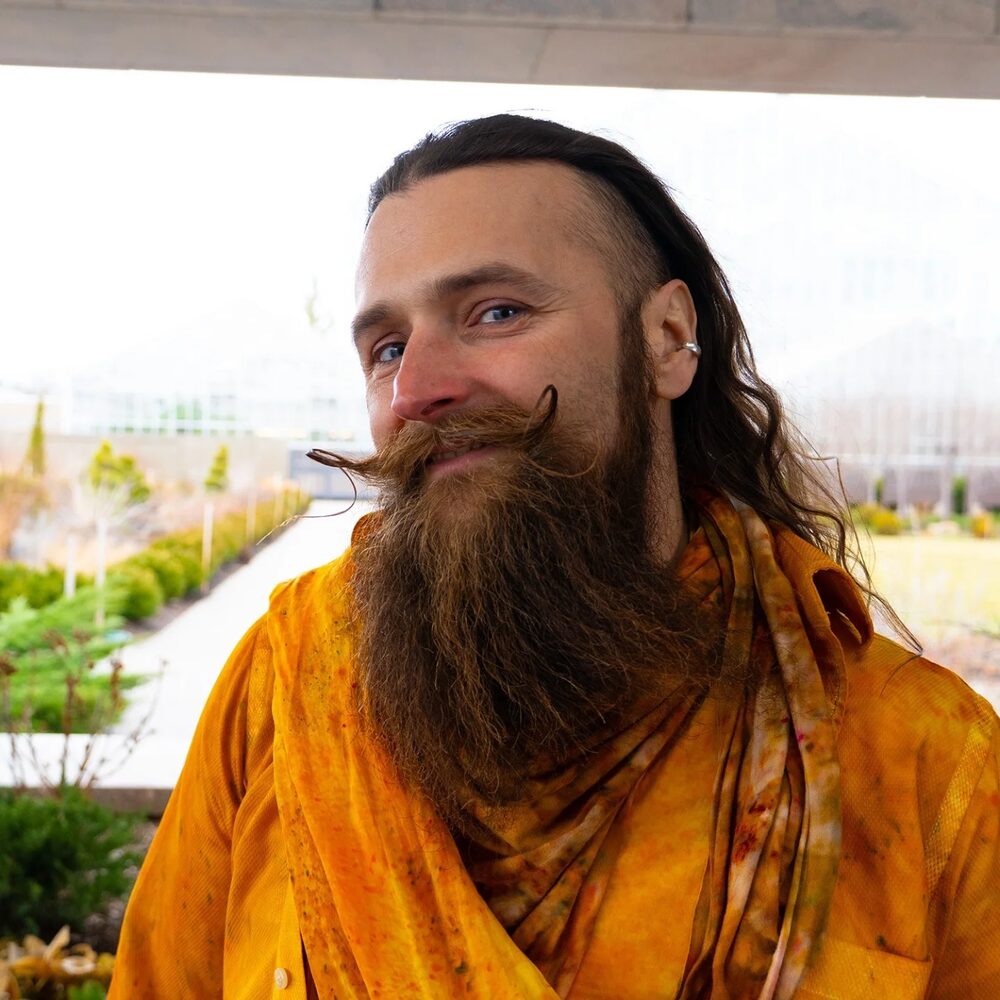 Portrait of Scott Van Sice with long beard in marigold tones
