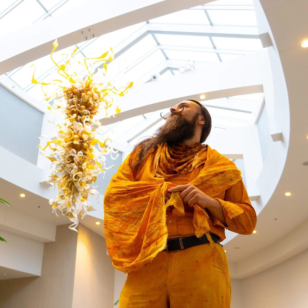 Scott beneath a glass chandelier