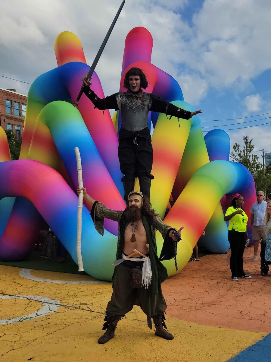 Two-high in front of a rainbow inflatable